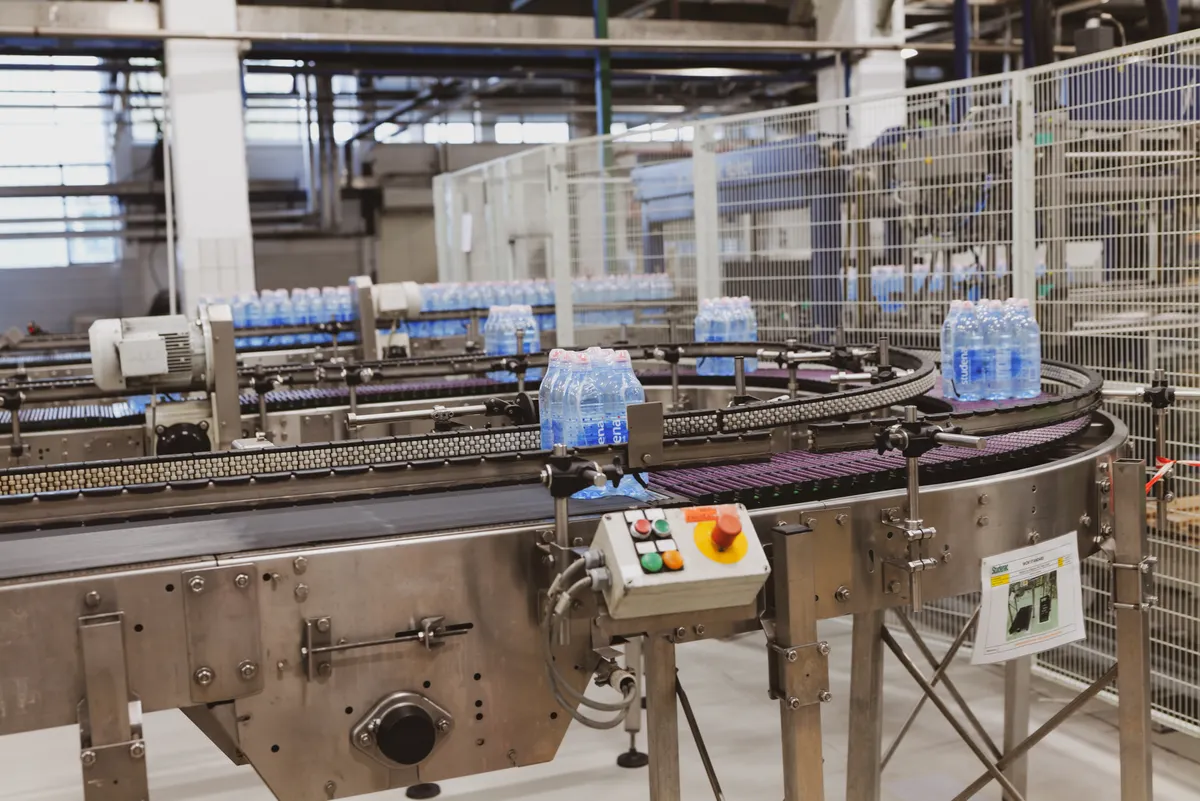 Automated beverage bottling line in a production facility